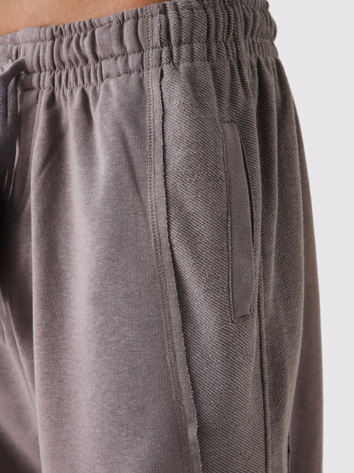 Stone Mauve Aim Shorts on model, relaxed-fit men's gym and casual shorts by GROOVY Pakistan