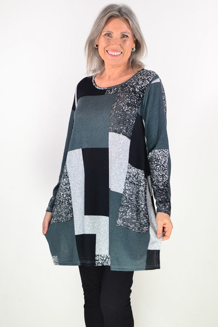 Black and grey geometric fleece tunic top by Hourglass, featuring a comfortable, stylish design with long sleeves and a relaxed fit.