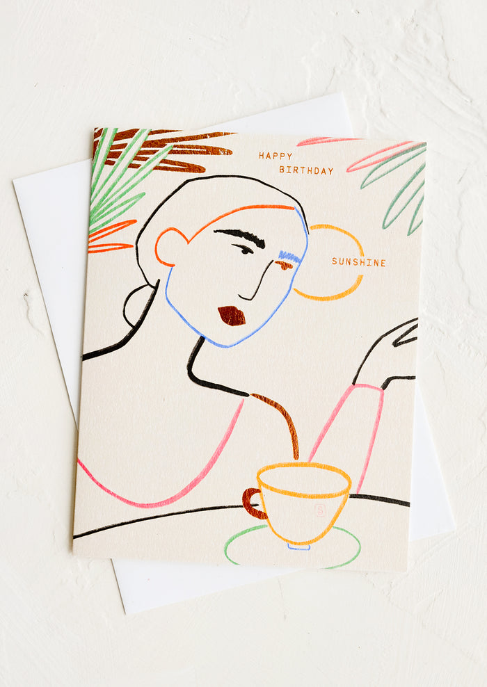 A greeting card with silhouette of woman drinking coffee, text reads "Happy birthday sunshine".