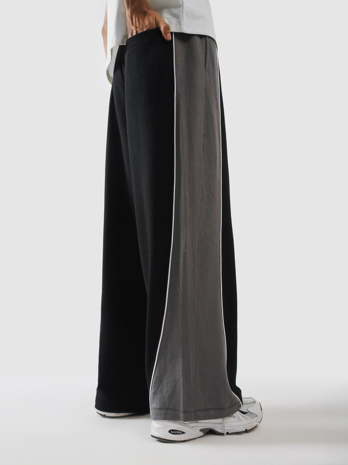 Side profile of black panelled terry sweatpants - GROOVY Pakistan