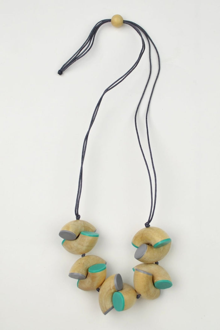 Green macaroni necklace by I Love Tunics, showcasing a colorful, playful beaded necklace with chunky green macaroni shapes.