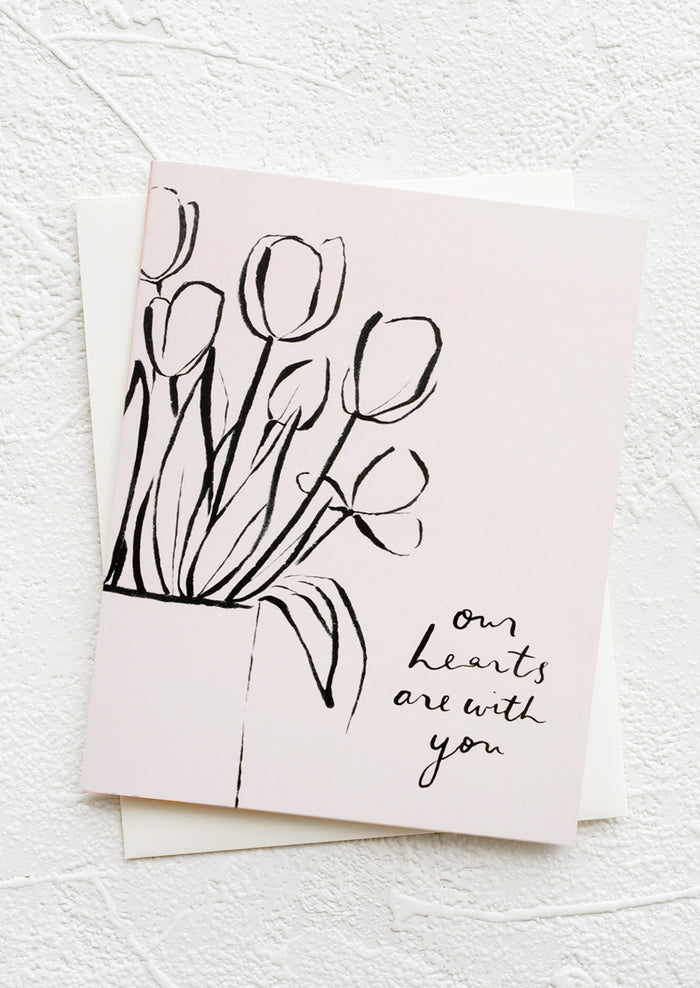 A greeting card featuring drawing of tulips and text reading "Our hearts are with you".