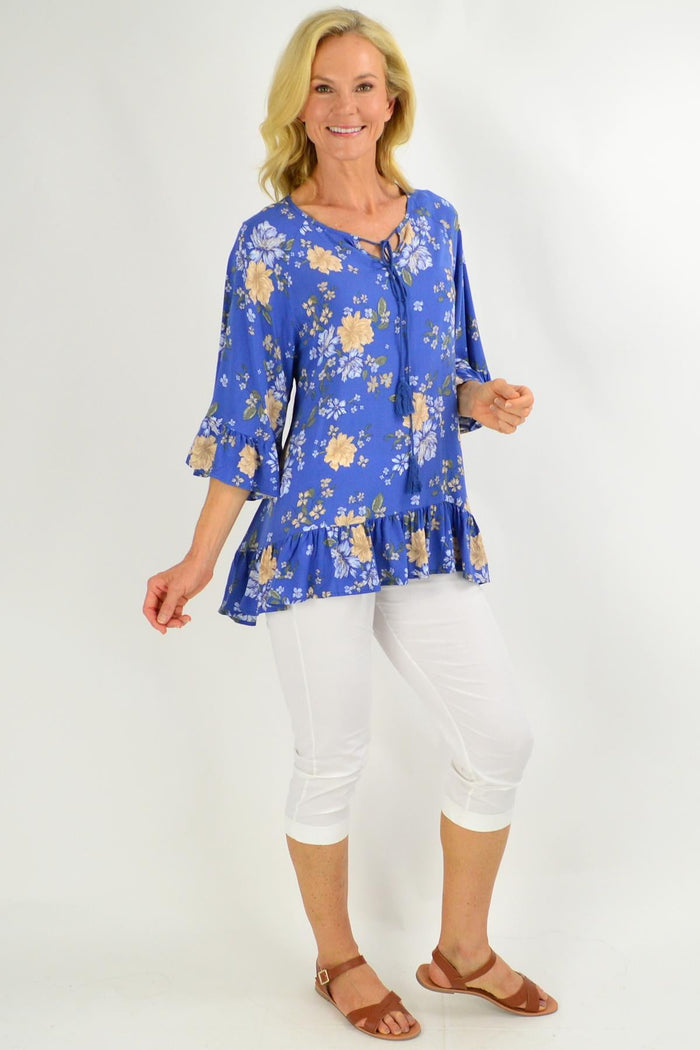 Blue floral tunic top with wide sleeves from New U collection, featuring a relaxed fit and vibrant floral pattern.