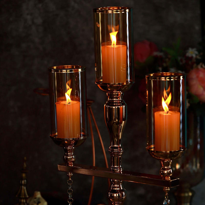 Elegant candle holders with lit candles in a decorative setting.