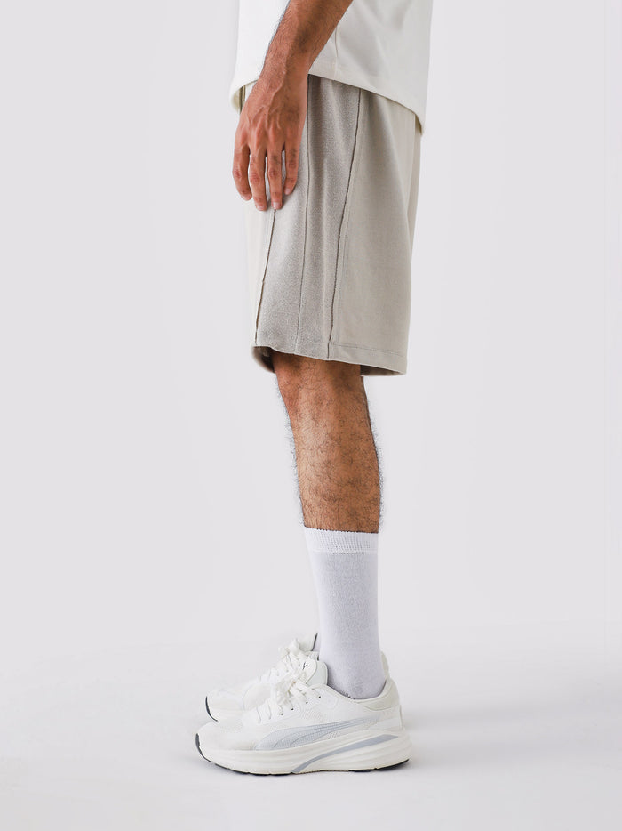 Ash Grey Aim Shorts on model, relaxed-fit men's gym and casual shorts by GROOVY Pakistan