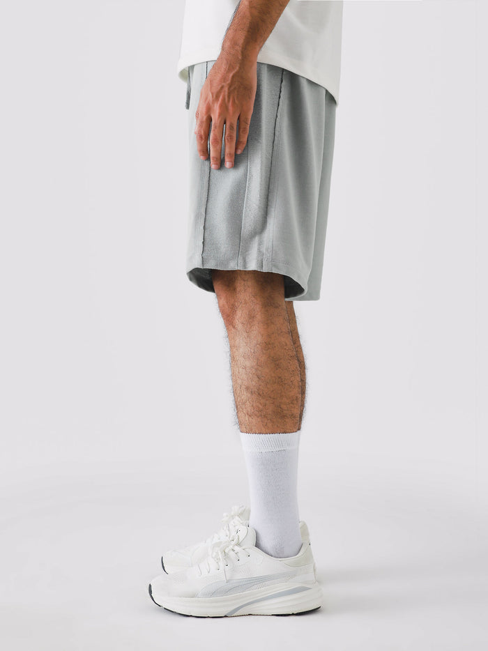 Cool Grey Aim Shorts on model, relaxed-fit men's gym and casual shorts by GROOVY Pakistan