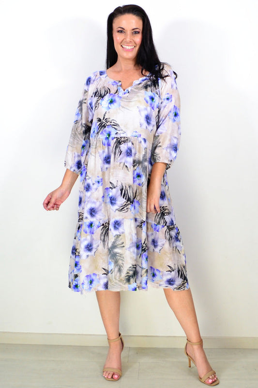 Beige and blue floral midi tunic dress by Hourglass, featuring a flowy fabric and elegant floral pattern.