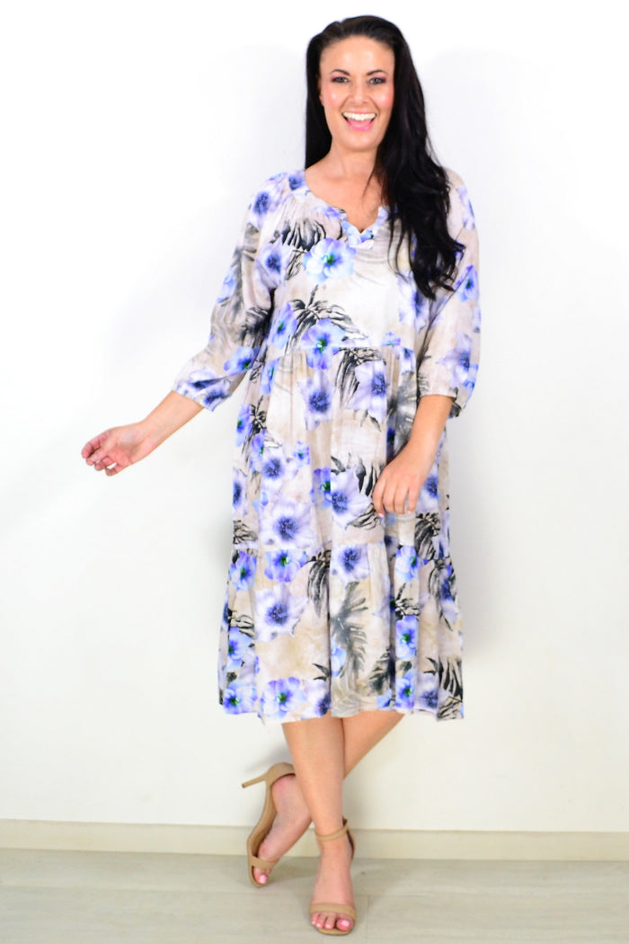 Beige and blue floral midi tunic dress by Hourglass, featuring a relaxed fit and lightweight fabric, displayed on a hanger.