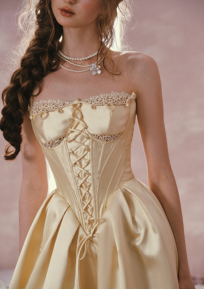 Detailed view of the structured satin and lace-trimmed neckline on Belle's Gilded