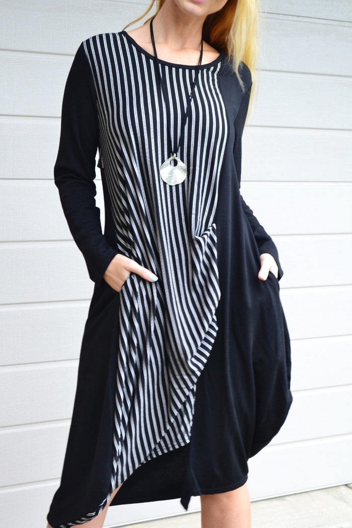 Black 3/4 sleeve stripe jersey tunic dress by Whispers, shown hanging with a relaxed fit and stylish design.