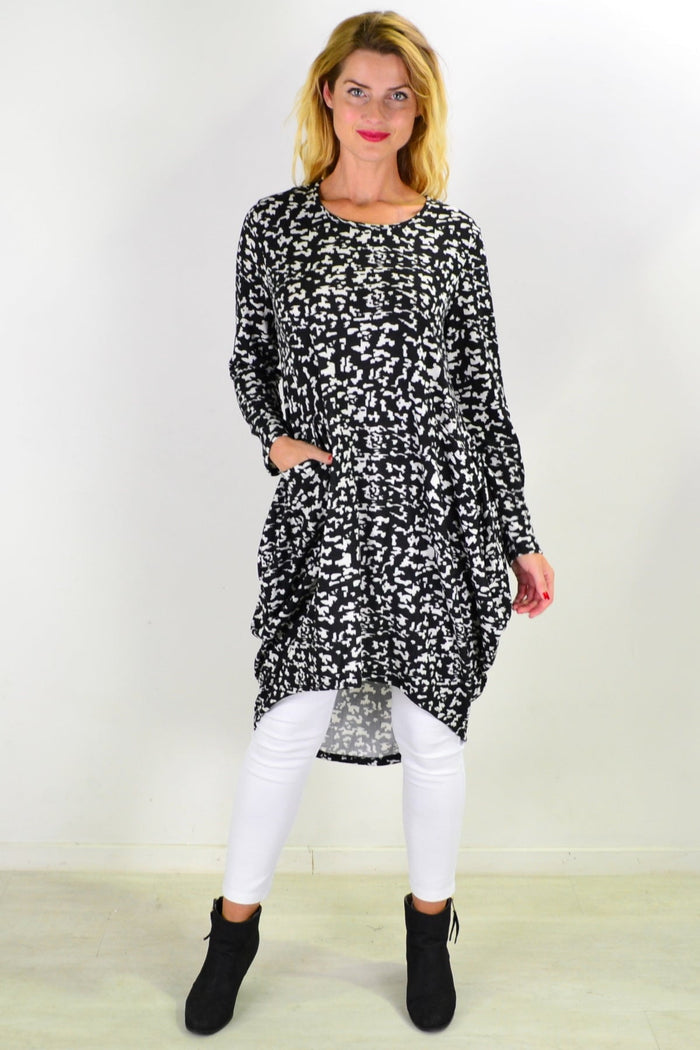 Black Digitech Knit Tunic Top by I Love Tunics, featuring a relaxed fit and long sleeves, displayed on a hanger.