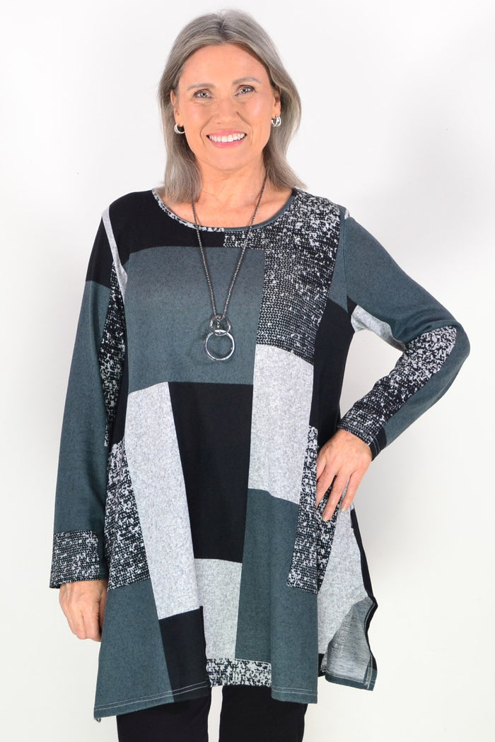 Black and grey geometric fleece tunic top by Hourglass, shown with a relaxed fit and long sleeves on a plain background.