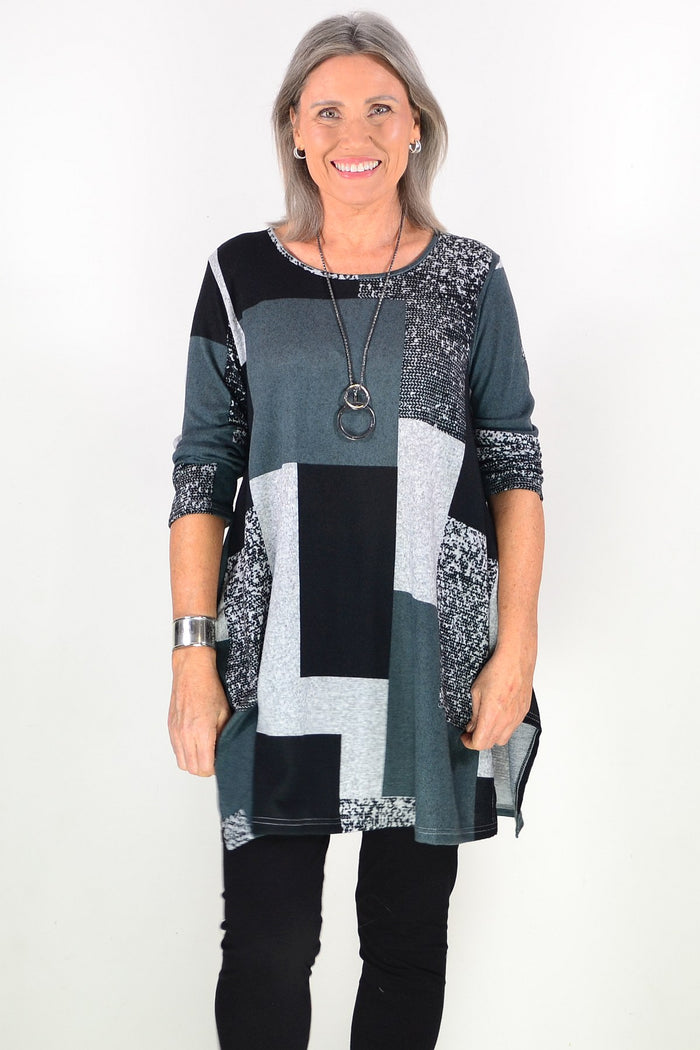 Black and grey geometric fleece tunic top by Hourglass, showcasing a relaxed fit with bold geometric patterns and soft fleece fabric.