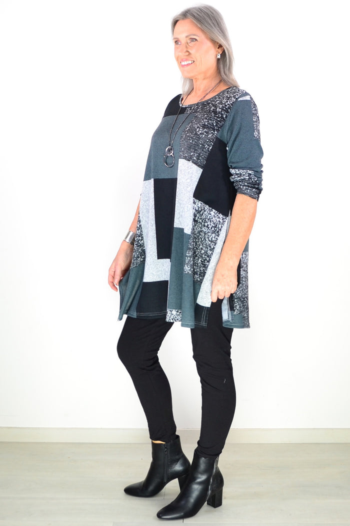 Black and grey geometric fleece tunic top by Hourglass, featuring a cozy, stylish design with a relaxed fit and long sleeves.