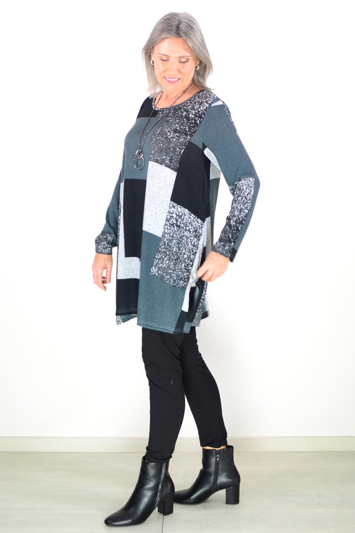 Black and grey geometric fleece tunic top by Hourglass, featuring a cozy, stylish design with a relaxed fit and long sleeves.