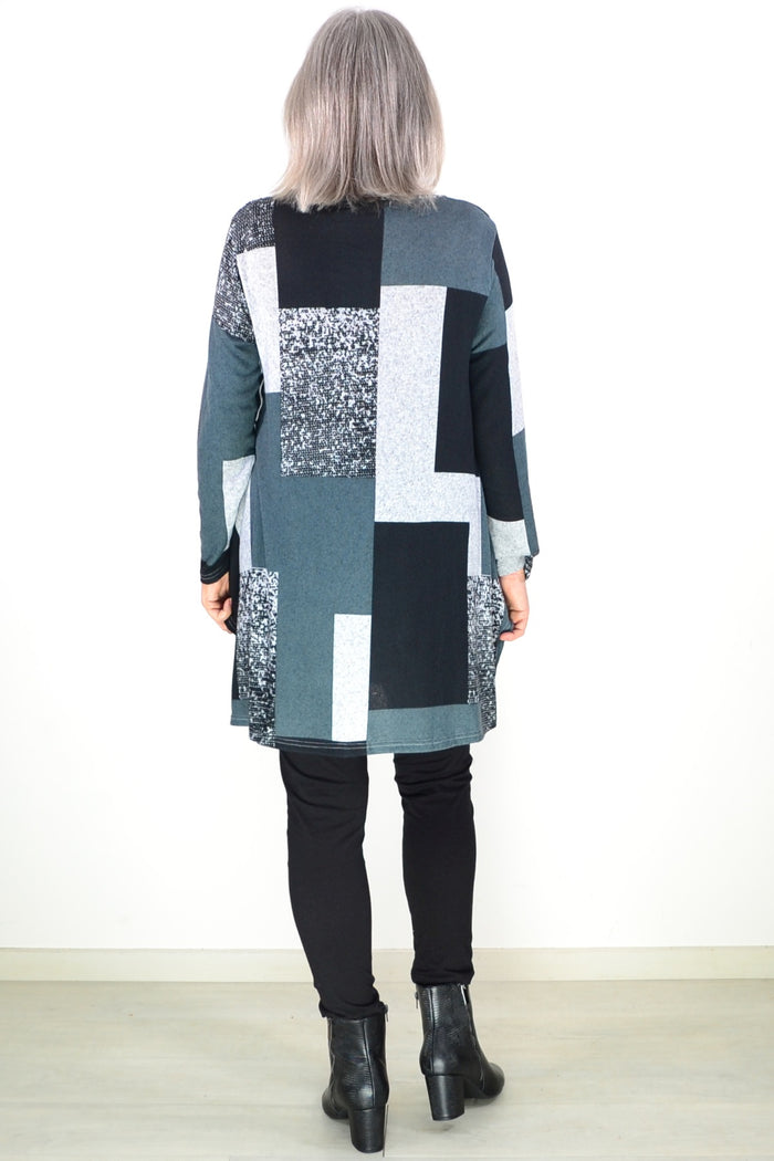 Black and grey geometric fleece tunic top by Hourglass, featuring a relaxed fit and stylish pattern, displayed on a hanger.