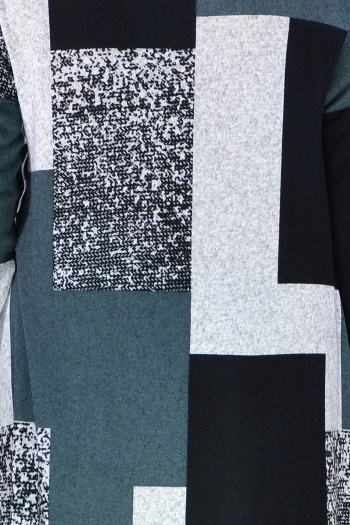 Black and grey geometric fleece tunic top by Hourglass, shown on model with long sleeves and relaxed fit.