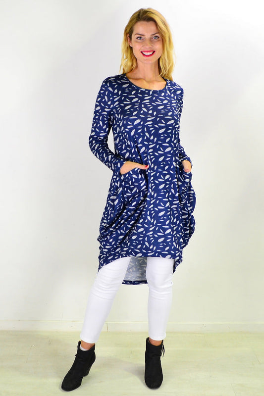 Blue floating leaf knit tunic top by I Love Tunics, featuring a relaxed fit and soft fabric, displayed on a hanger.