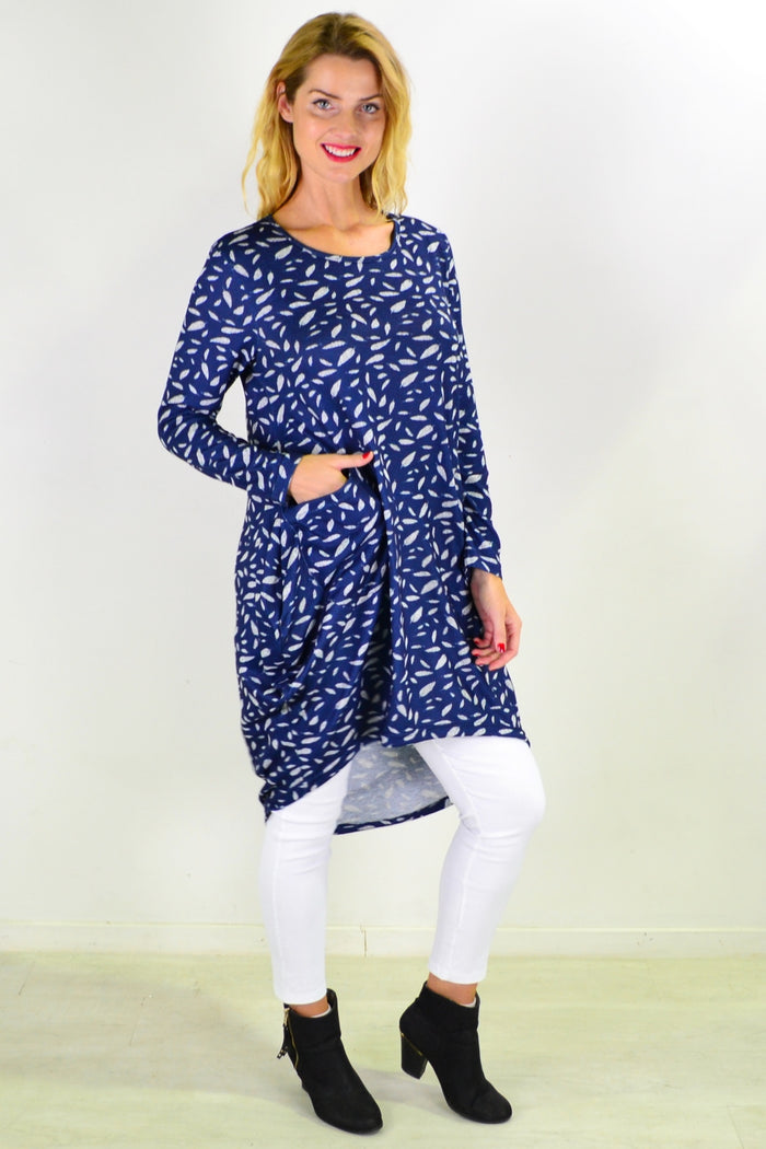 Blue floating leaf knit tunic top by I Love Tunics, shown on a hanger with detailed fabric texture and relaxed fit.