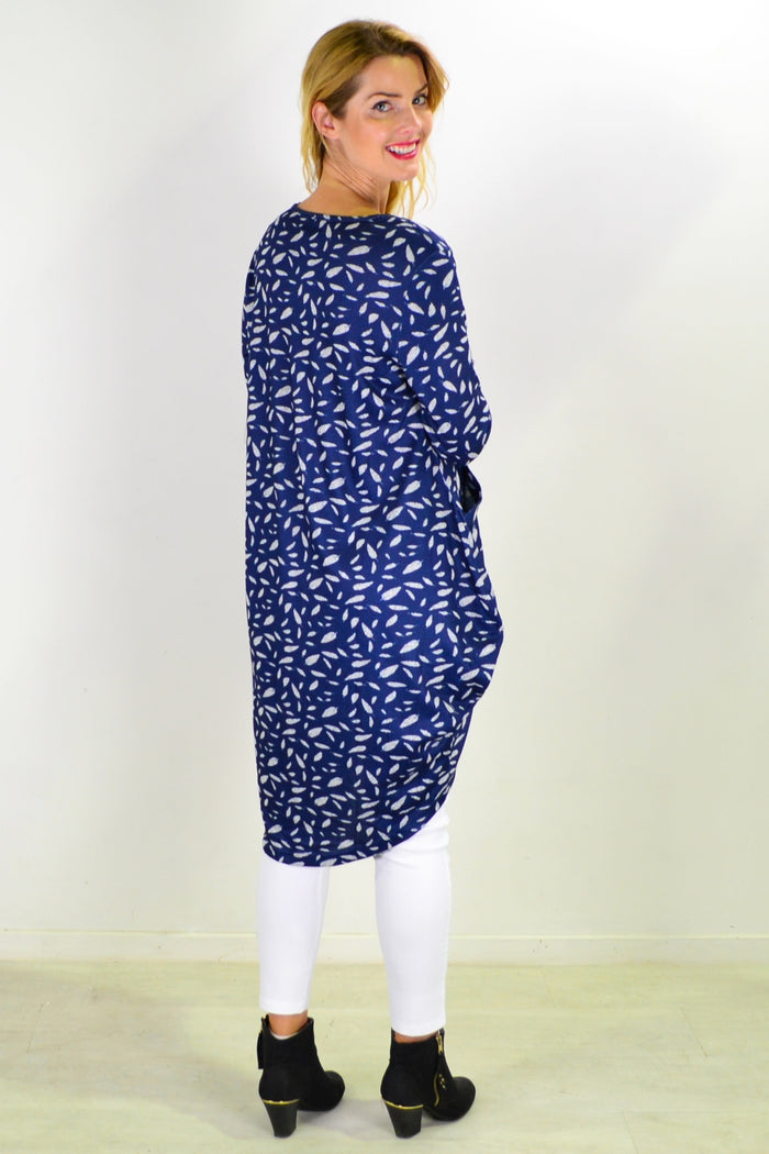 Blue floating leaf knit tunic top from I Love Tunics displayed on a hanger with a textured fabric and relaxed fit.