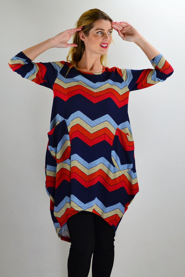 Hourglass Candy Lane wool knit tunic top displayed on a hanger, showcasing its cozy texture and stylish design.