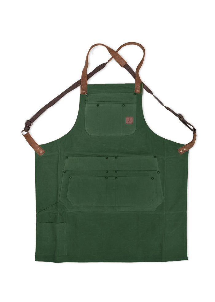 Green apron with brown straps and multiple pockets, designed for utility and style. Ideal for cooking or crafting activities.
