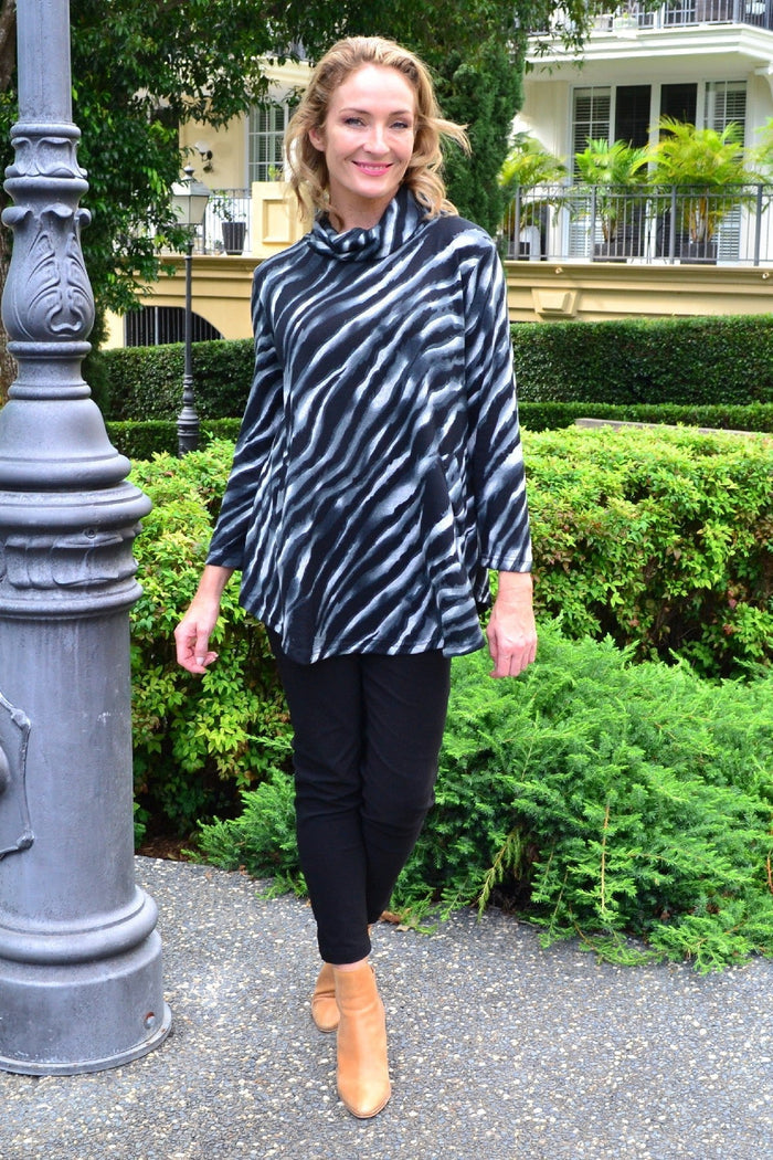 Charcoal zebra print rolled neck tunic top by Willow Tree, featuring a stylish design and comfortable fit, shown on a model.