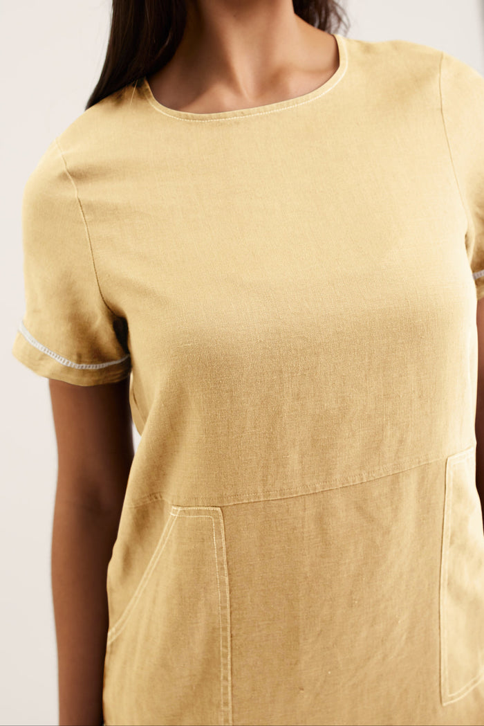 Yellow dress with short sleeves and a pocket on a plain background