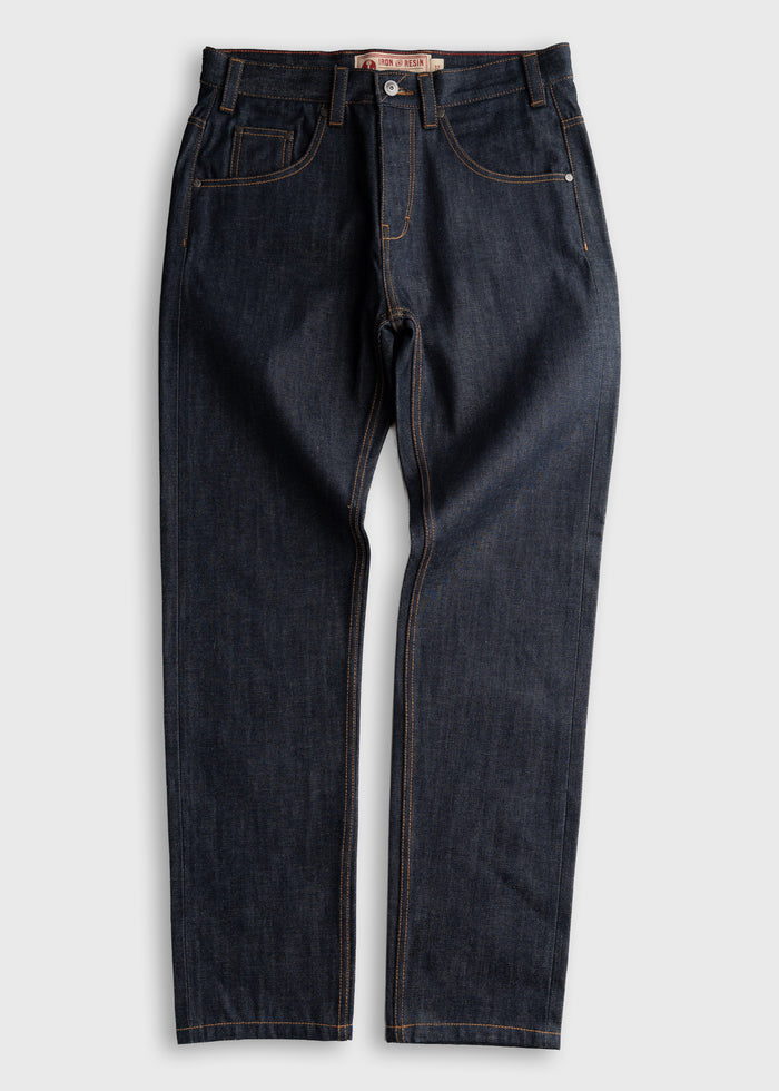 Dark blue denim jeans with orange stitching, button closure, and five-pocket design, laid flat on a light gray background.