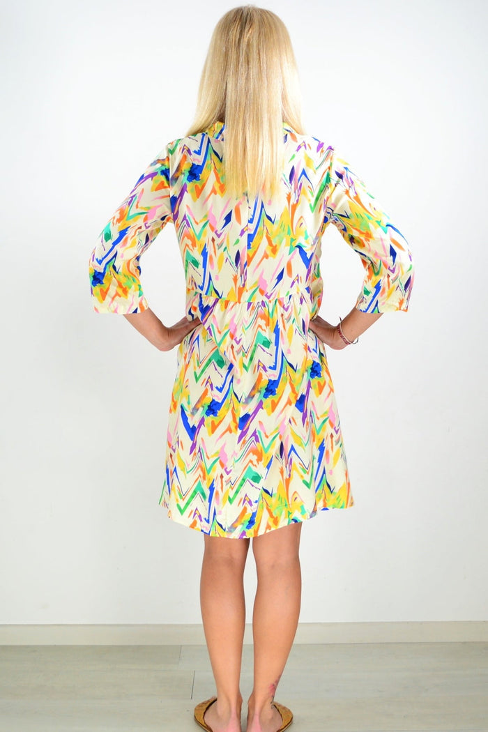 Cream paint splash collared tunic shirt by Hourglass, featuring a relaxed fit with vibrant paint design and button front detail.