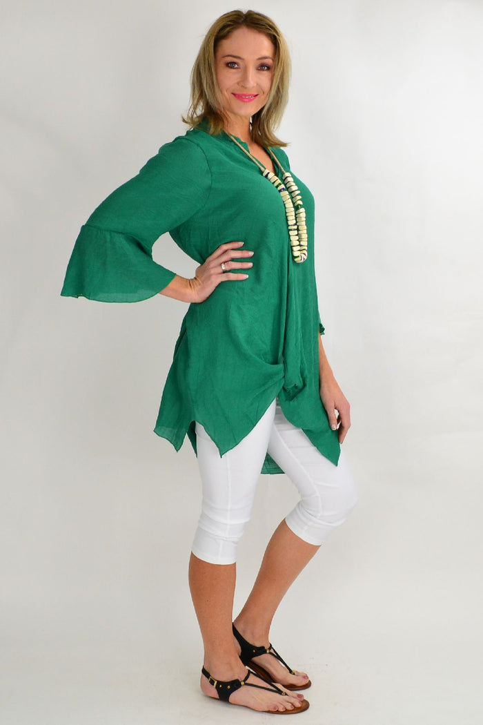 Green tunic top by Wishstone featuring a crisp, lightweight fabric and a relaxed fit, displayed on a hanger with a plain background.