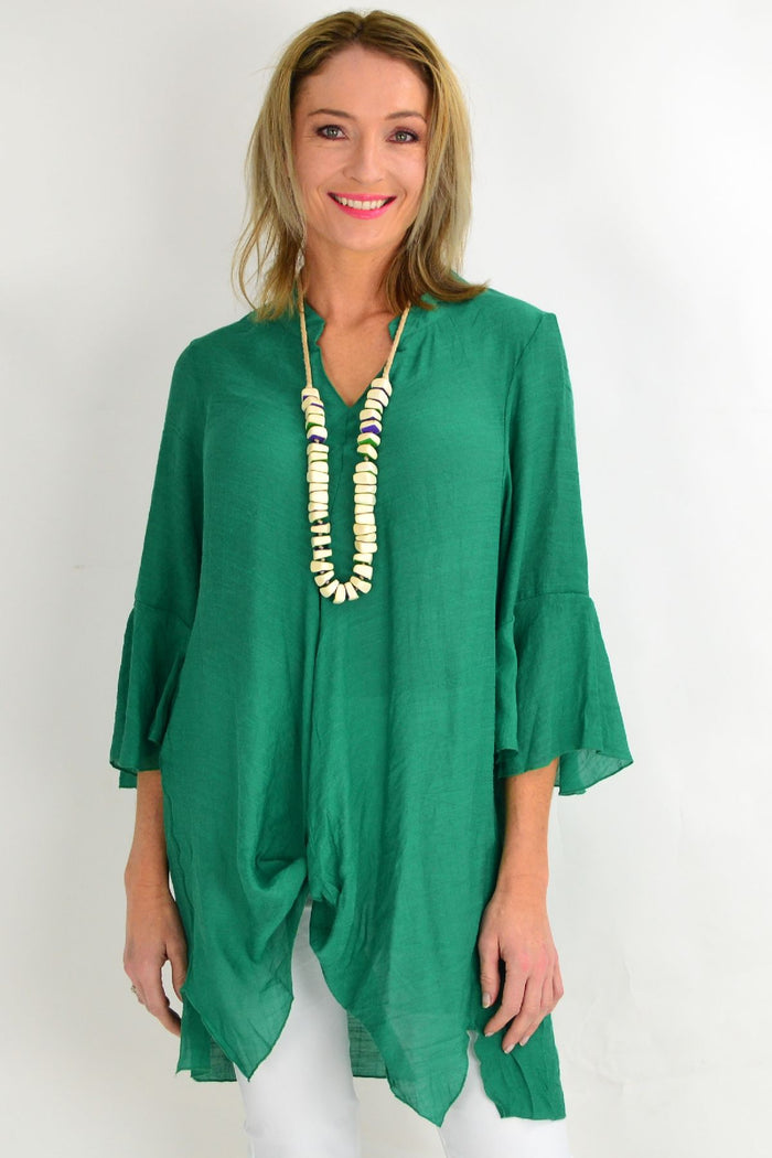 Wishstone green tunic top with long sleeves and a relaxed fit, shown on a hanger against a neutral background.