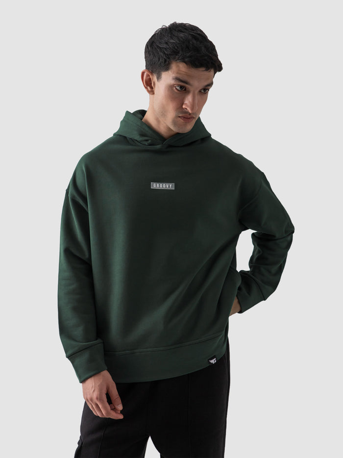 Dark green oversized hoodie male model full body front view Pakistan – GROOVY