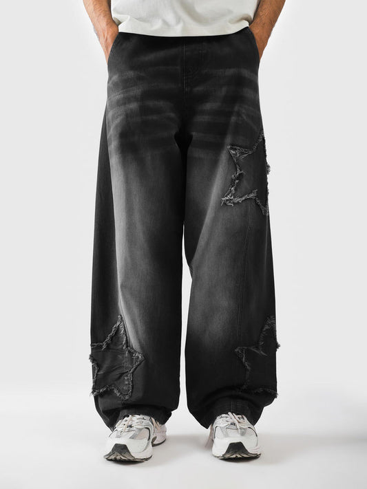 Mineral washed black star trousers front view - Distressed Star Pants | GROOVY Pakistan