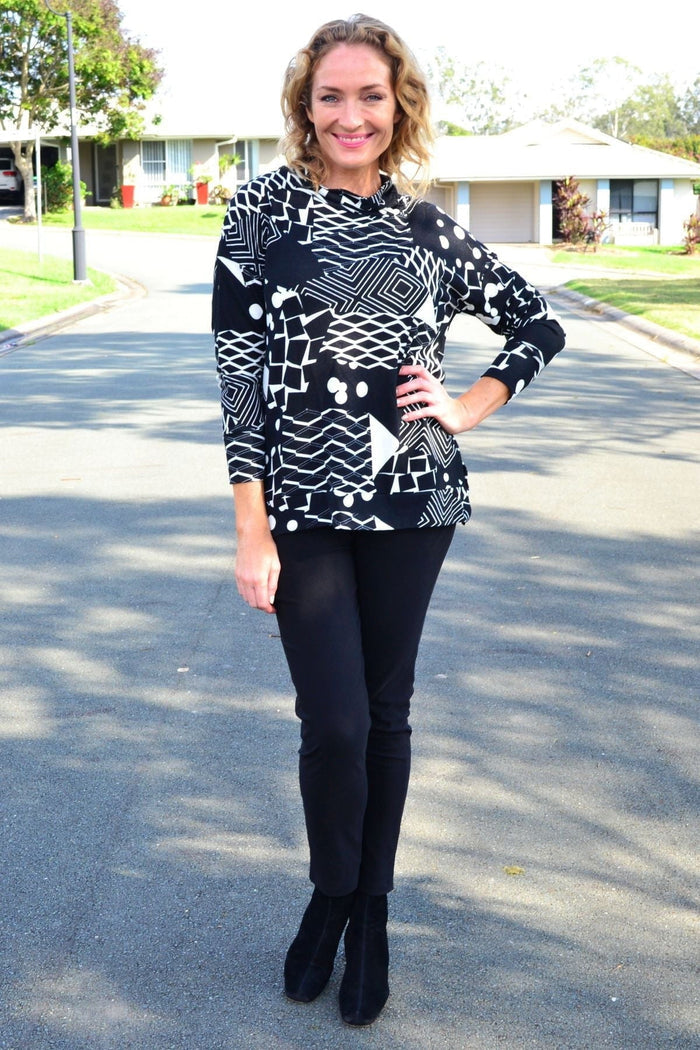 Wishstone Dotty Do Little long sleeve fleece tunic top with colorful dot pattern and cozy fabric, displayed on a hanger.