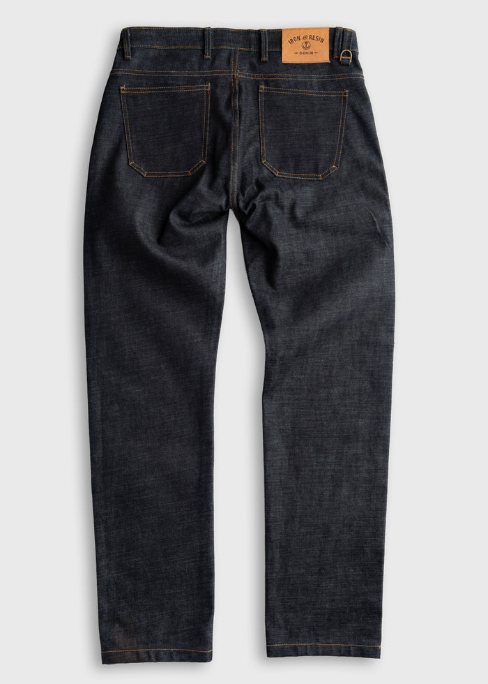 Dark denim jeans with two back pockets and a leather patch on the waistband, displayed on a light gray background.