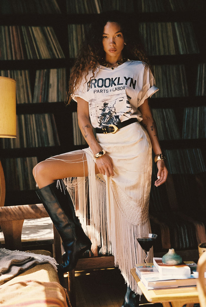 Cream fringe and satin midi skirt with refined detailing and a flattering silhouette.