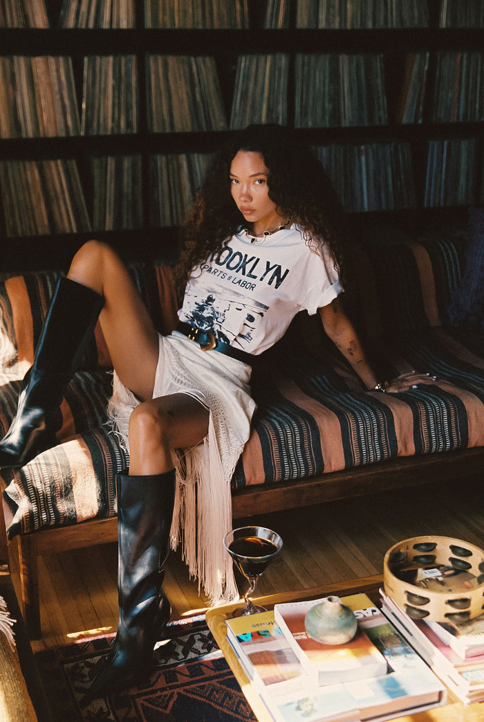 Back view of the cream fringe and satin midi skirt showing the silhouette and fit.