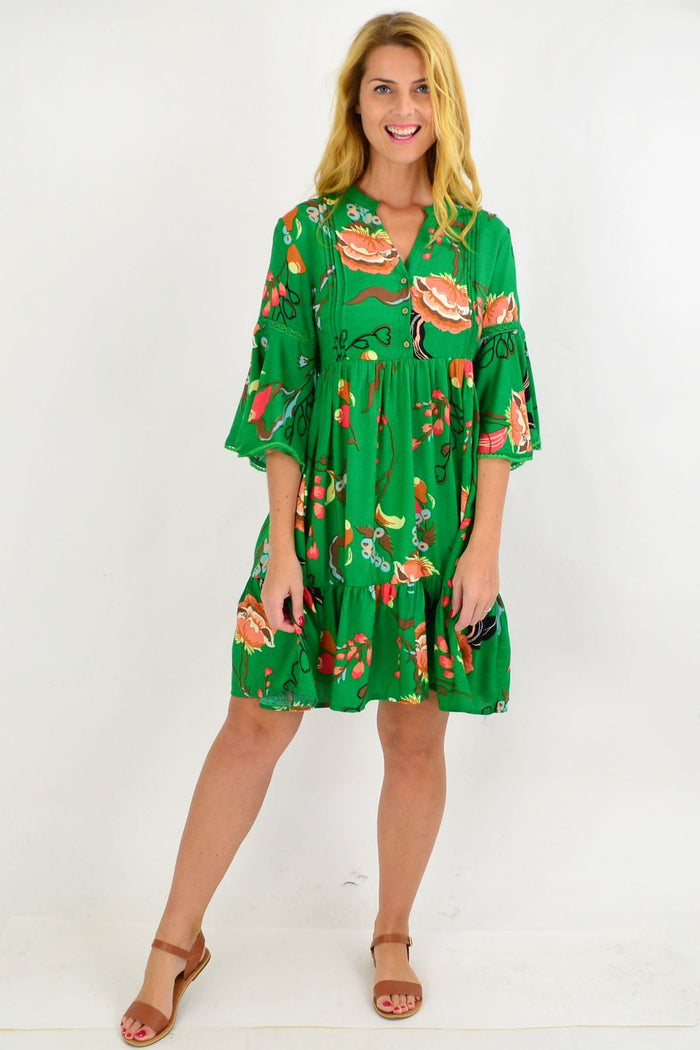Willow Tree green Betty bell sleeve tunic dress hanging on a wooden hanger, showcasing bell sleeves and relaxed fit.