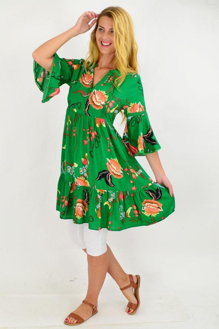 Willow Tree green Betty bell sleeve tunic dress displayed on a hanger, showcasing its relaxed fit and bell sleeve design.