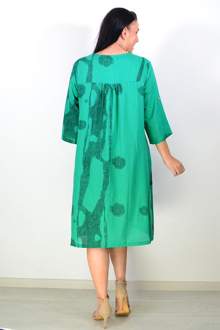 Green linen blend tunic dress by Ruby Rain, featuring a relaxed fit and natural fabric texture, displayed on a hanger.