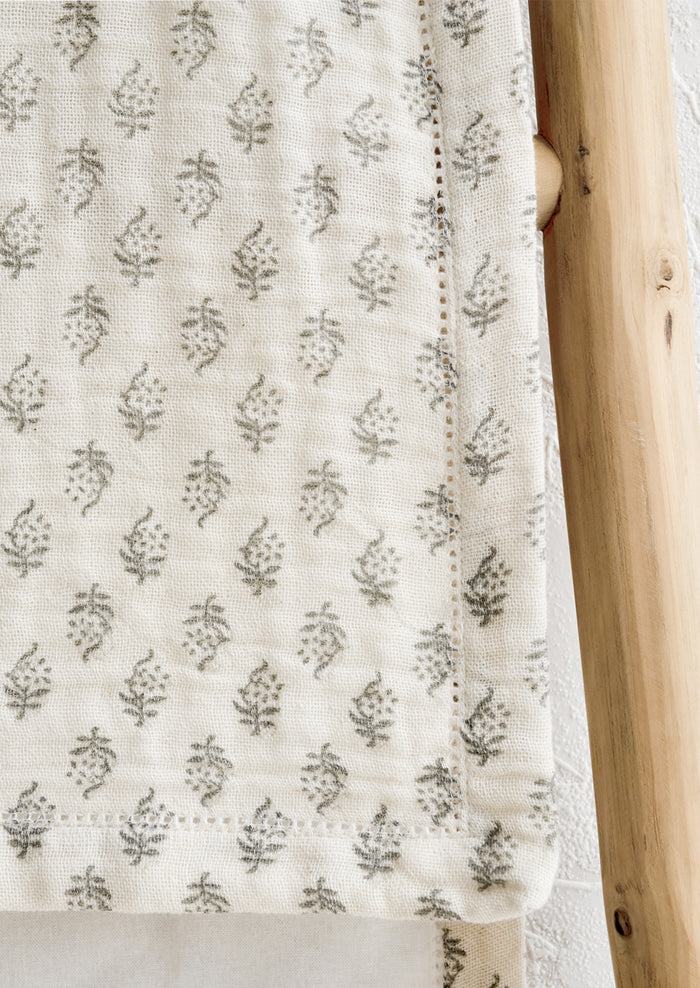 A table runner with hemstitch detailing.