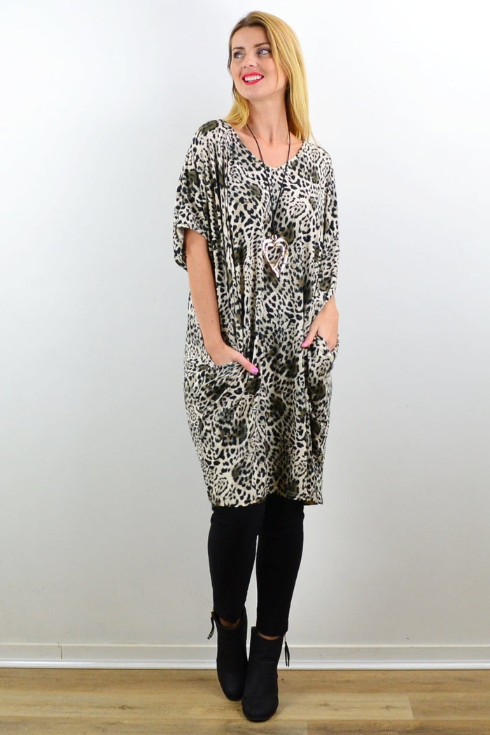 Willow Tree leopard print relaxed tunic dress displayed on a hanger, showcasing its laid-back style and bold animal print.