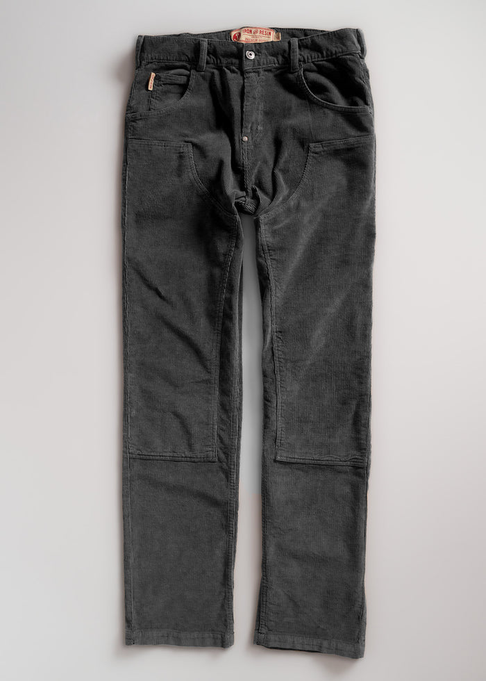 Dark gray corduroy pants with front pockets and button closure, laid flat on a light background.