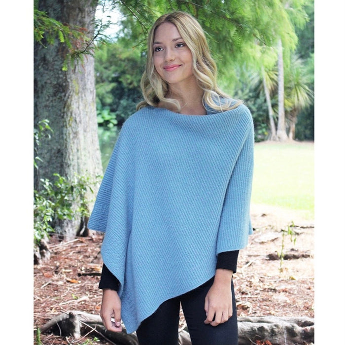 Woman smiling in Mist colour poncho