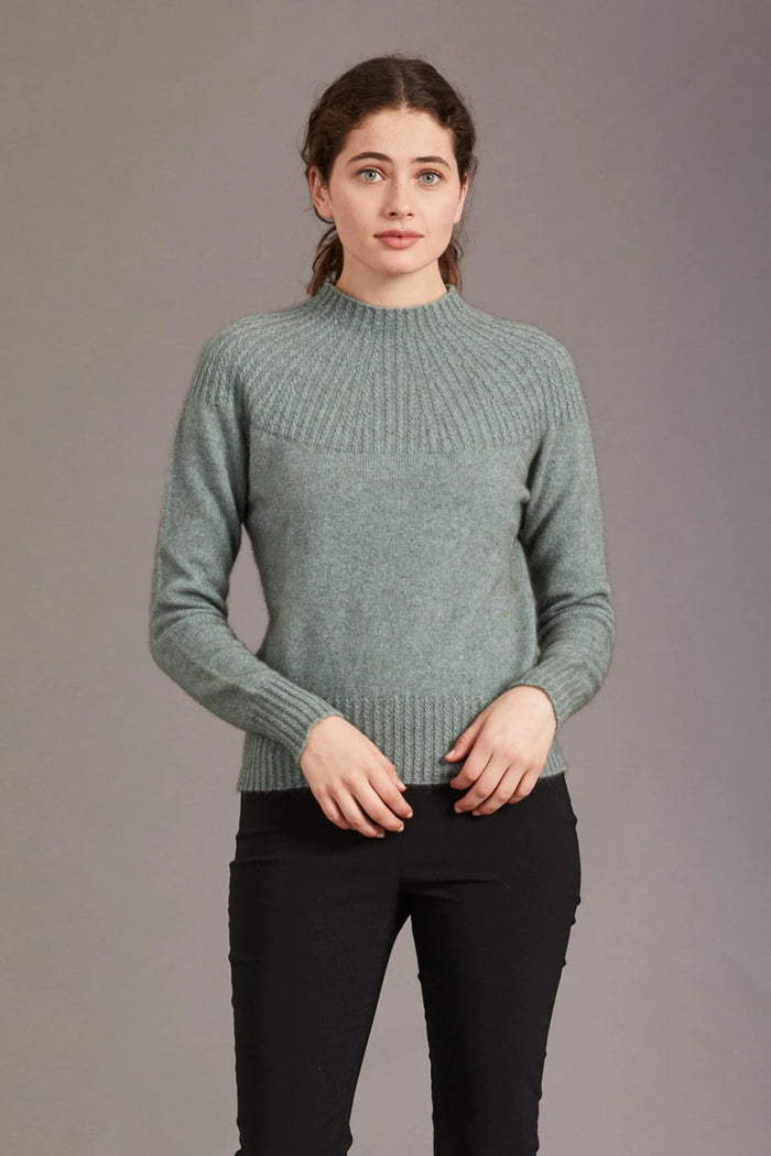 Model wearing Yoke neck cable jersey in colour Mint