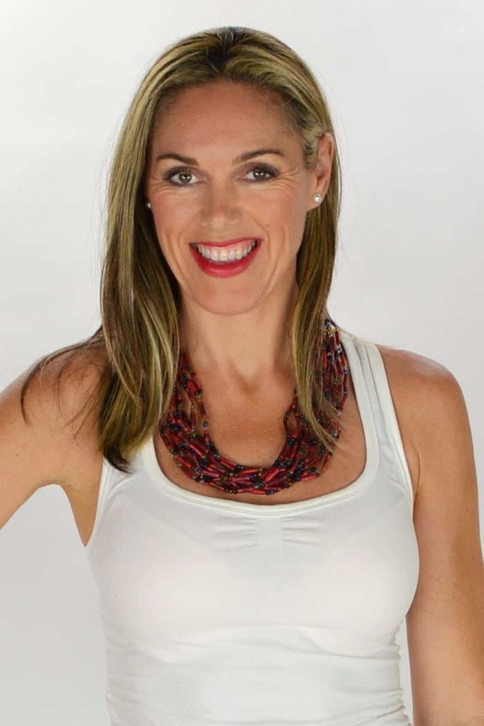 Multilayered red beads necklace by I Love Tunics featuring multiple strands and vibrant red beads displayed on a white background.