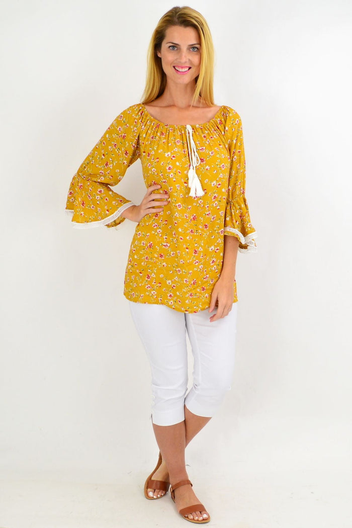Mustard floral boho tassel off-shoulder rayon tunic top by Missy Q featuring colorful flower patterns and tassel detailing.