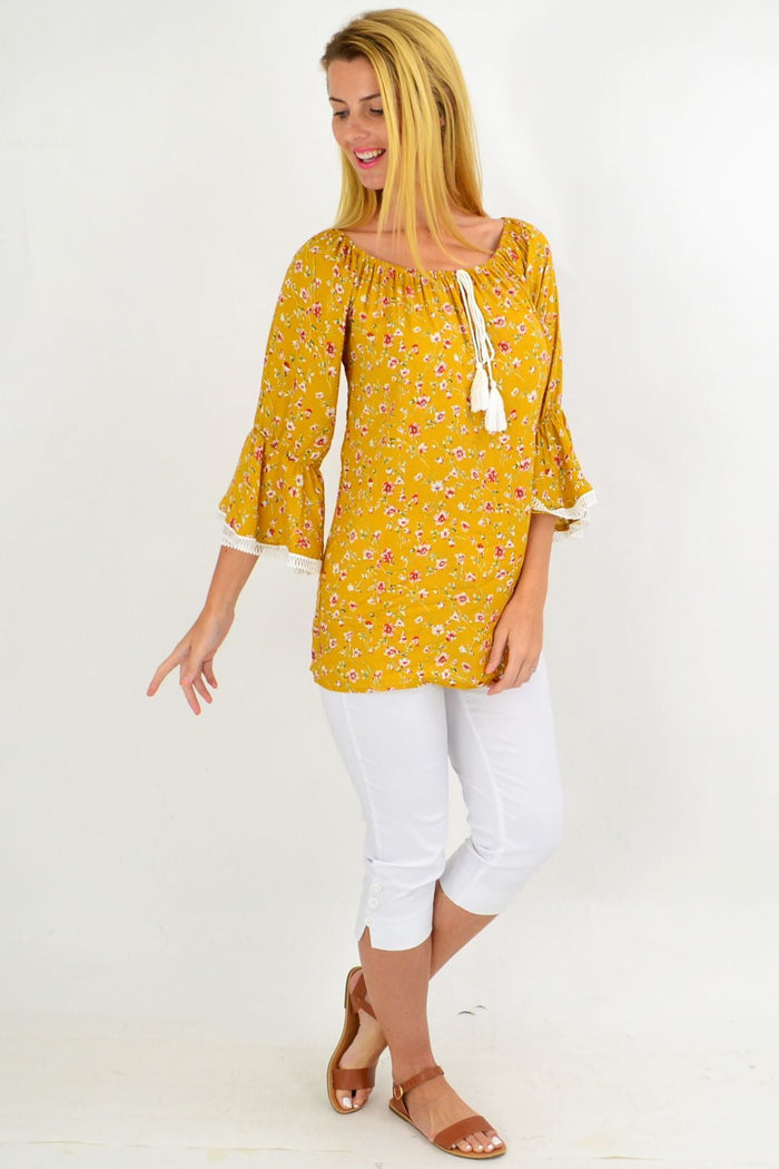 Mustard floral tassel off-shoulder tunic top by Missy Q featuring boho-print rayon fabric and tassel details.