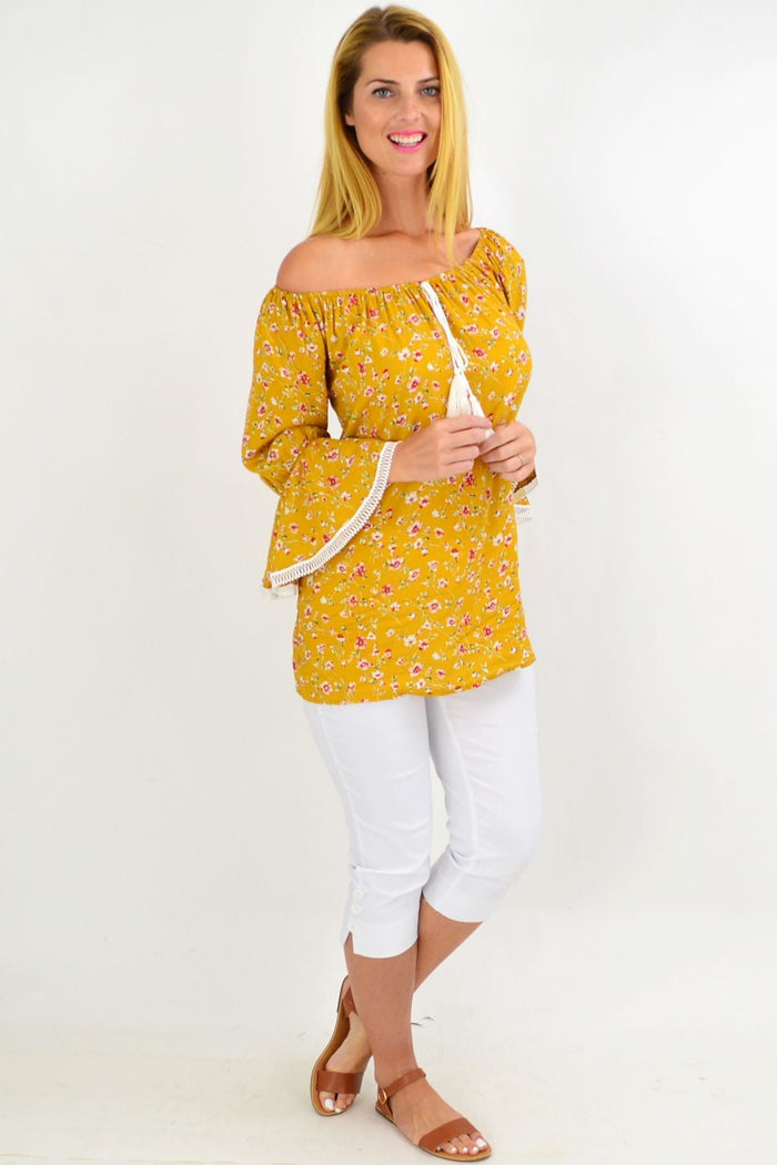 Mustard floral boho tassel off-shoulder rayon tunic top by Missy Q with vibrant flower print and tassel details.